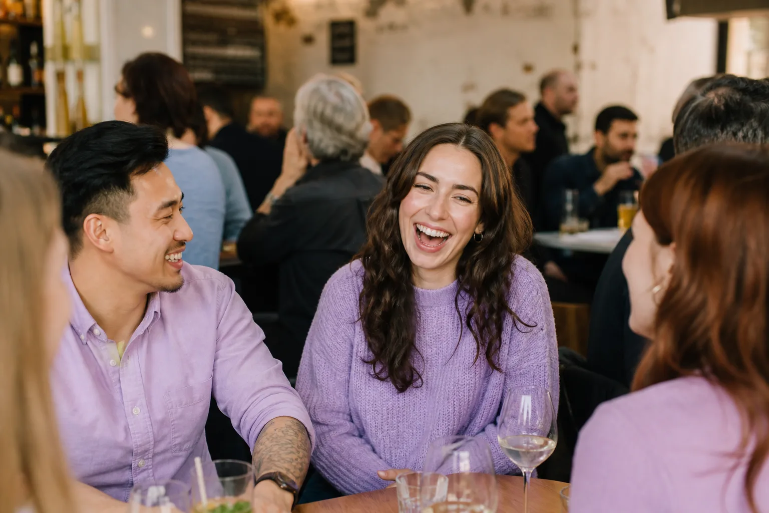 People talking over drinks at a relaxed evening event in Guildford